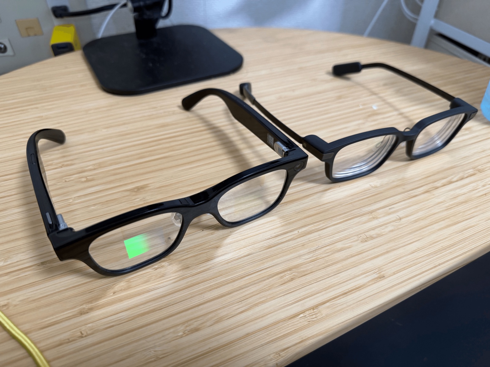 Rokid Glasses and Even G2 on a desk